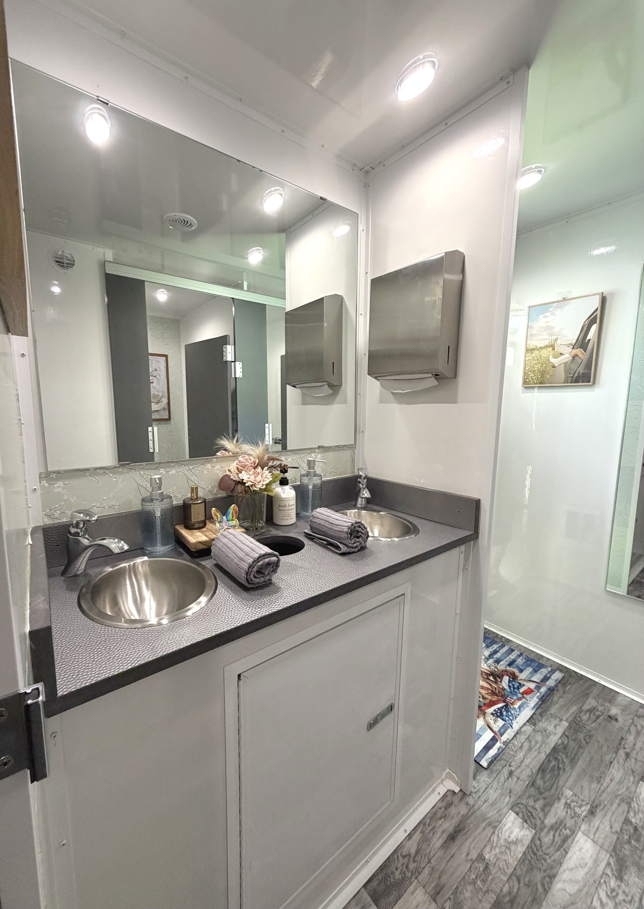 Double vanity sinks with running water in luxury restroom trailer