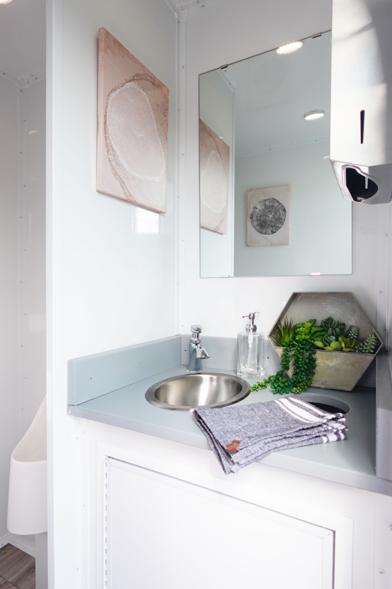 Private stall with flushing toilet in luxury restroom trailer